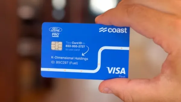 Person displaying a Coast Visa fleet card with Ford Pro branding