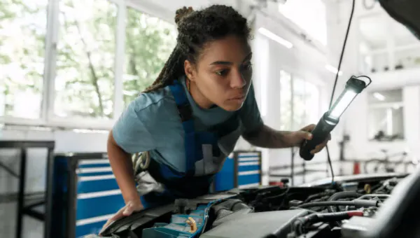 Female technician working on engine diagnostics